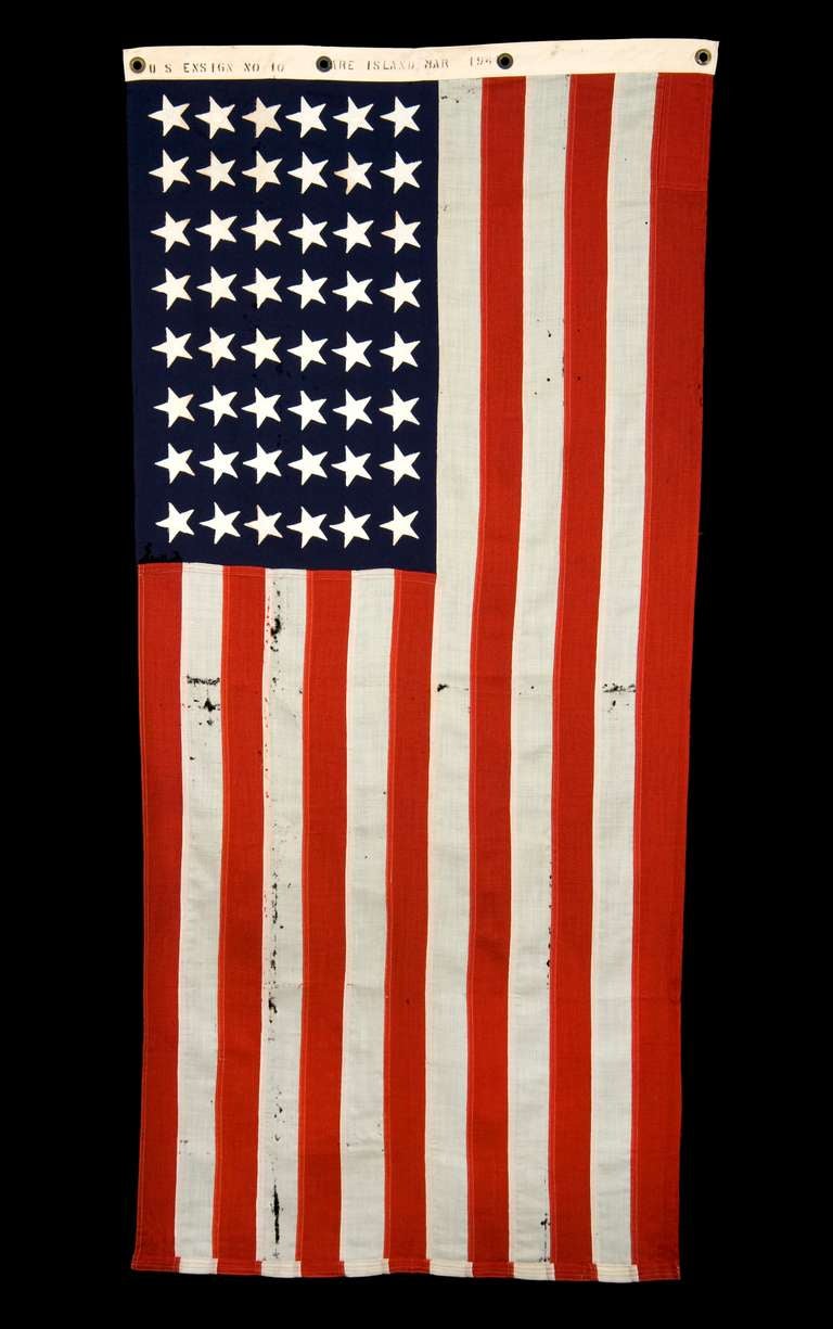 48 STAR, U.S. NAVY SMALL BOAT ENSIGN, MADE AT MARE ISLAND, CALIFORNIA DURING WWII, SIGNED AND DATED MARCH, 1941:

48 star American national flag, made during World War II and signed along the reverse side of the hoist with a black stencil that
