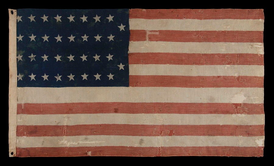 34 STARS IN 2 ROWS WITH 2 STARS WITH OFFSET AT THE FLY END, A UNION ARMY CAMP COLORS, ONE OF ONLY TWO EXAMPLES I HAVE EVER SEEN IN THIS EXACT FORM, 1861-1863, OPENING TWO YEARS OF THE CIVIL WAR:


34 star American national flag, printed on a wool