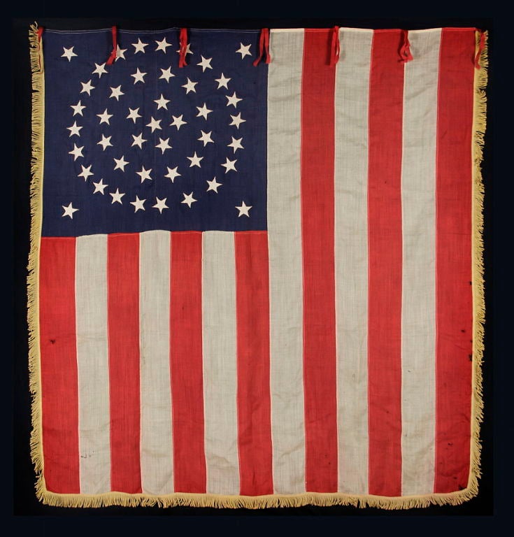 RARE AND EXCEPTIONAL 44 STAR UNITED STATES INFANTRY BATTLE FLAG WITH A MEDALLION CONFIGURATION, GOLD FRINGE, AND RED WOOL TIES, LATE INDIAN WARS, WYOMING STATEHOOD, 1890-1896:<br />
<br />
This rare 44 star American national flag is a United
