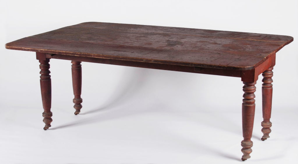 RED PAINTED AMERICAN DROPLEAF FARM TABLE ON SUBSTANTIAL, TURNED, COUNTRY SHERATON LEGS, FOUND IN THE ADIRONDACK REGION OF NEW YORK STATE, 1830-1860:

First surface red paint and substantial, country Sheraton legs are the best features of this