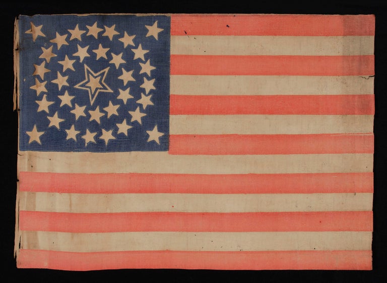 35 STARS, 1863-65, CIVIL WAR PERIOD, WEST VIRGINIA STATEHOOD, MEDALLION CONFIGURATION, HALOED CENTER STAR:

35 star American national parade flag, printed on coarse, glazed cotton and bearing a beautiful medallion configuration that has a huge,