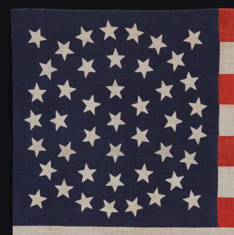 44 STARS, WYOMING STATEHOOD, 1890-1896, RARE IN THIS PERIOD WITH A WREATH CONFIGURATION:

44 star American parade flag with triple wreath medallion star configuration, printed on cotton. This highly desired star pattern is seen primarily in flags