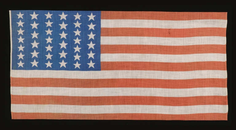 39 STARS ON A FLAG WITH AN UNUSUALLY ELONGATED FORMAT AND TWO SIZES OF STARS IN ALTERNATING COLUMNS, NEVER AN OFFICIAL STAR COUNT, 1876:

 39 star American parade flag, printed on cotton bunting. This is one of only three styles known that use