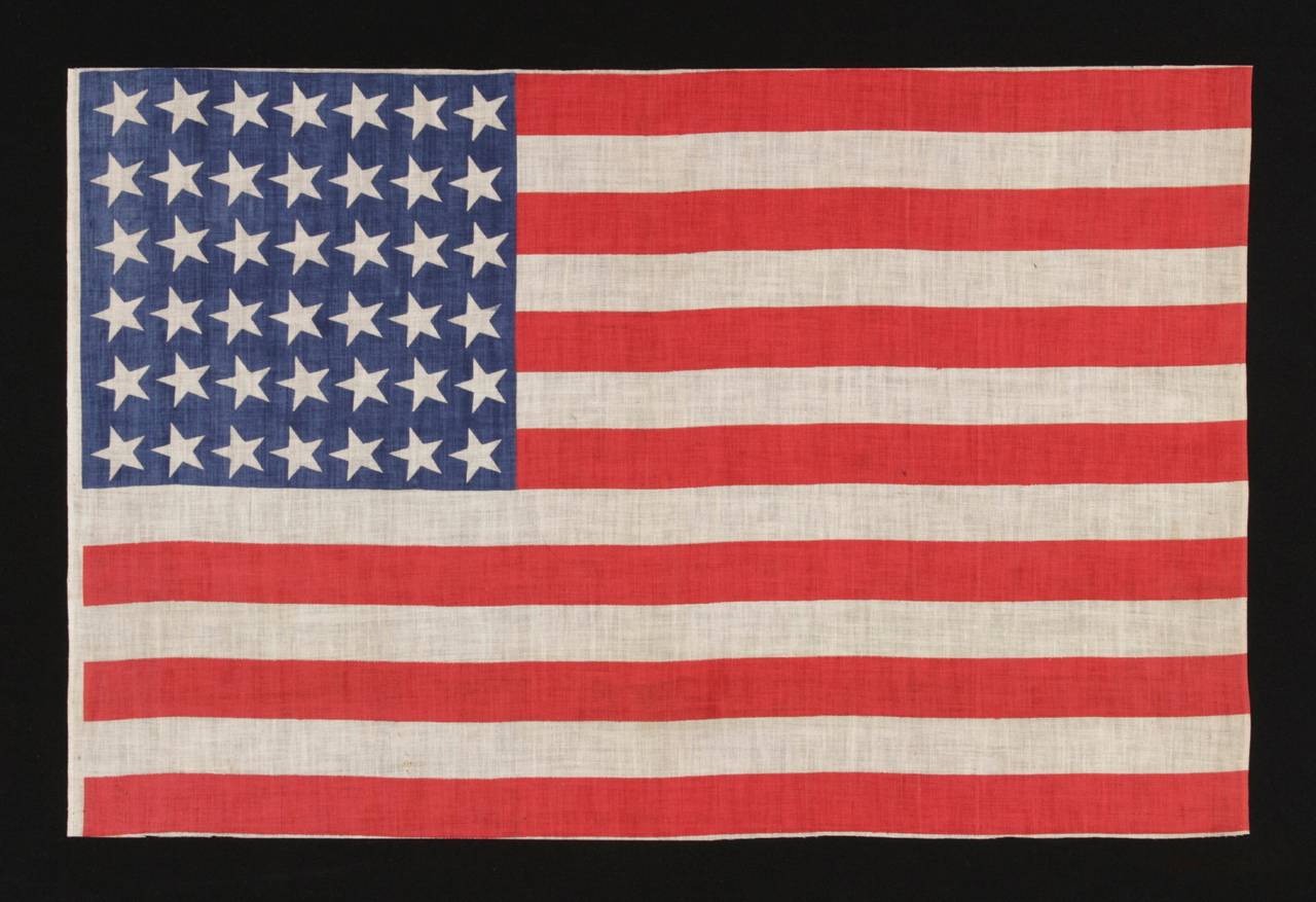42 canted stars, never an official star count, 1889-1890, Washington statehood:

42 star American parade flag, printed on cotton. Note how the stars, which are arranged in a rectilinear fashion, are canted at a uniform angle in the 11:00 position.