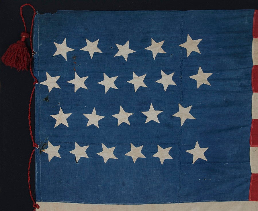 22 STARS, A SOUTHERN-EXCLUSIONARY FLAG, WITH AN ODDLY PLACED LINEAL STAR FIELD AND LARGE, HAND-MADE RED WOOLEN TASSELS ON A RED WOOLEN CORD, PROBABLY MADE BETWEEN 1863 AND 1864:

Hidden symbolism is abundant in American national flags of the Civil
