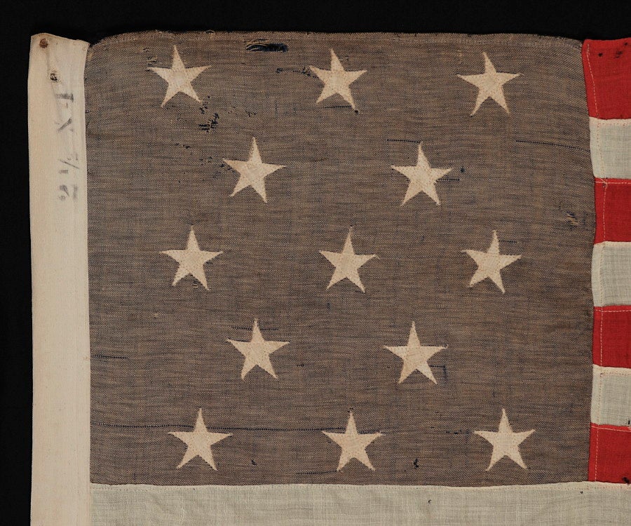 13 STARS IN A 3-2-3-2-3 PATTERN ON A SMALL-SCALE FLAG OF THE 1890's-1910 ERA; UNUSUAL BLUE CANTON WITH GOLD OVERTONES:

13 star flag of the type made from roughly the last decade of the 19th century through the first quarter of the 20th century.