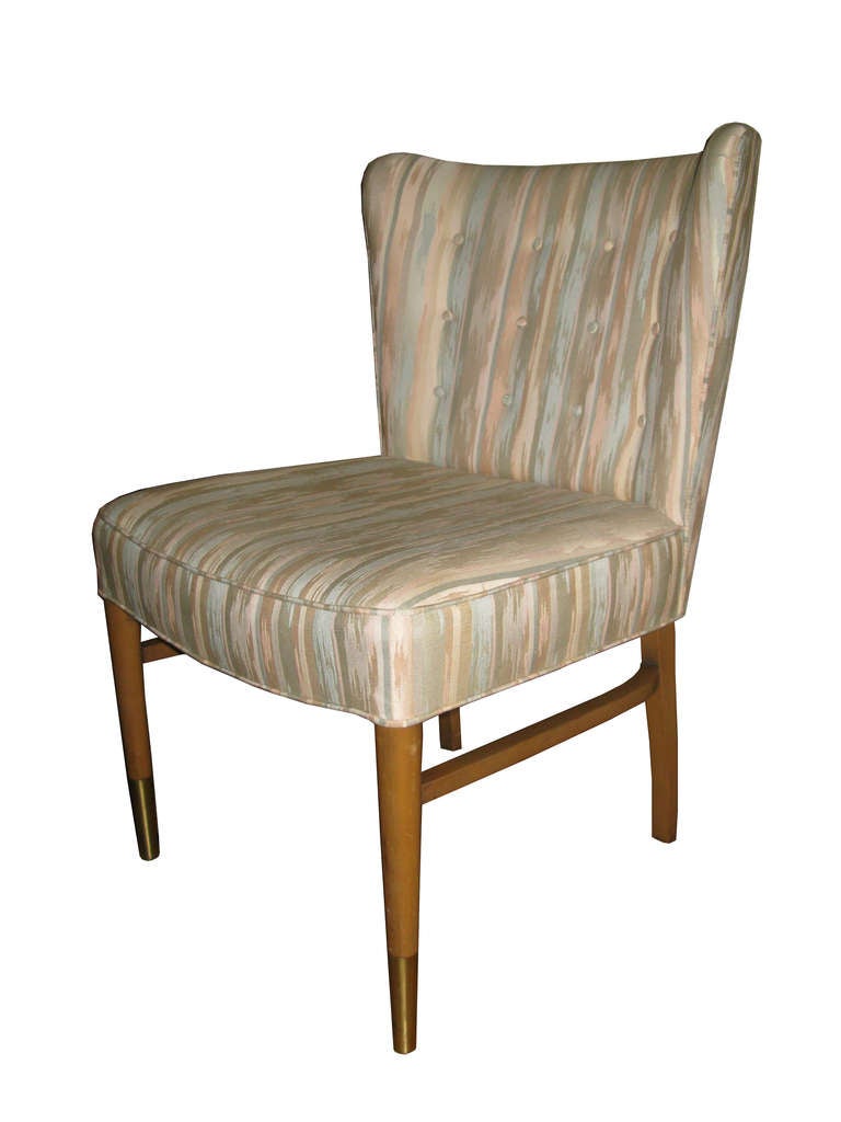 A set of 6 dining chairs designed by Paul Frankl. Wood legs with brass sabots and unique pastel print upholstery. 