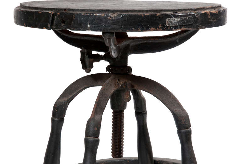 This wood stool is a blend of wood and cast iron base with a swiveling wood top. The height can be adjusted.