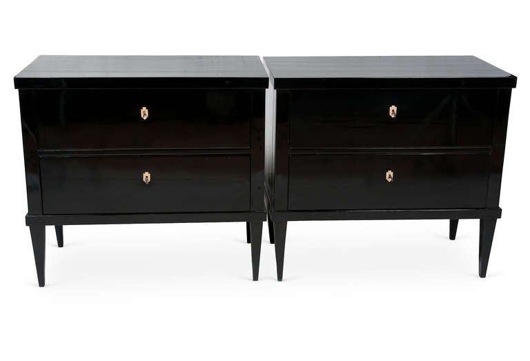 Pair of black lacquer Biedermeier chests with tapered legs.  Working keys with bone escutcheon detail on each drawer.