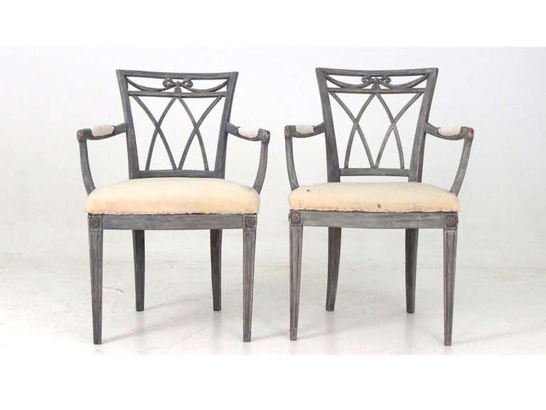 These two wood framed armchairs have amazing detail throughout the back and legs. Seat and elbow cushions are upholstered in a cream fabric.