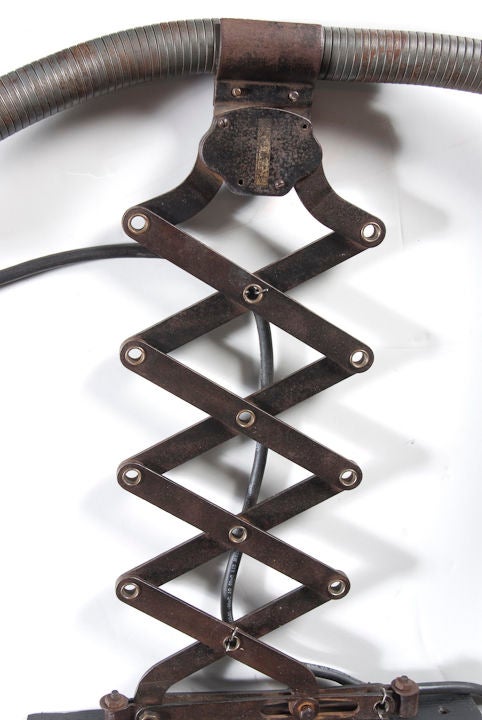 Unique scissor arm sconce made from old industrial parts