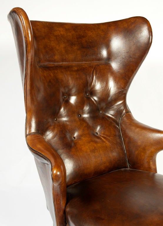 This Jean De Merry brown wing back arm chair ReEdition fits into every design style from rustic to ultra-modern.