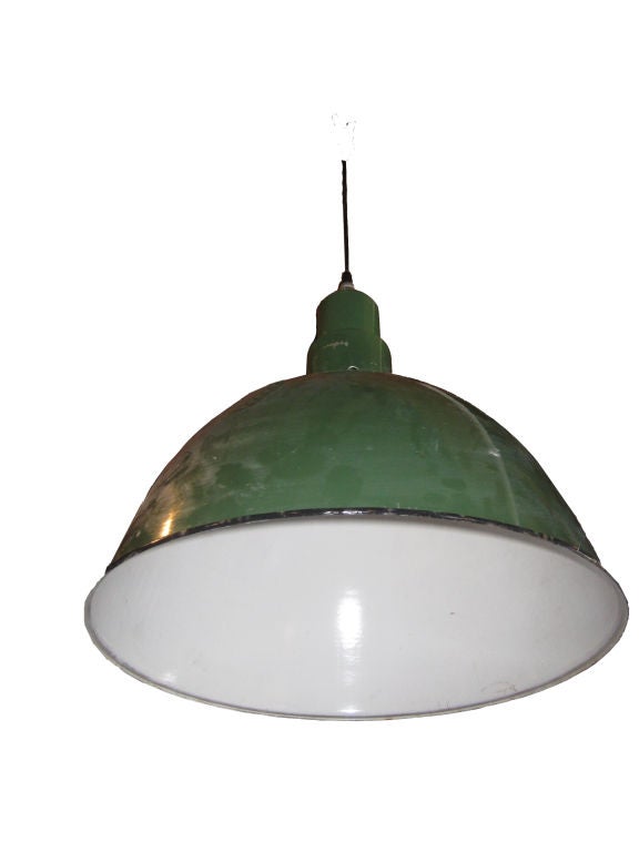 Large green porcelain bowl shades. Exterior is green, interior is white with black edging. Single socket, maximum wattage 150. Suspended from 8' black rubber electric cord with dark bronze canopy. Priced Individually.