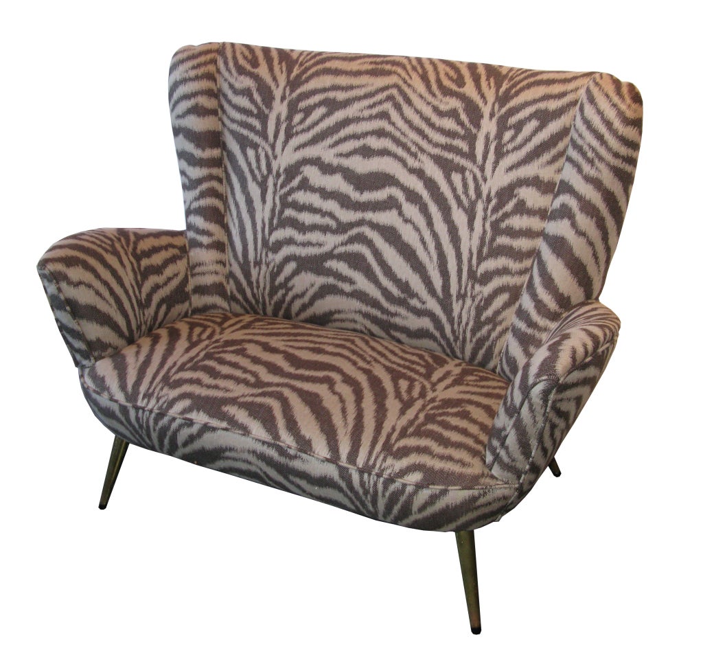 This Mid-Century Italian settee just received a sophisticated update with new upholstery in soft, yet striking, light brown and cream tiger stripe. Small and sleek, this settee is the perfect little spot for an intimate conversation for two.