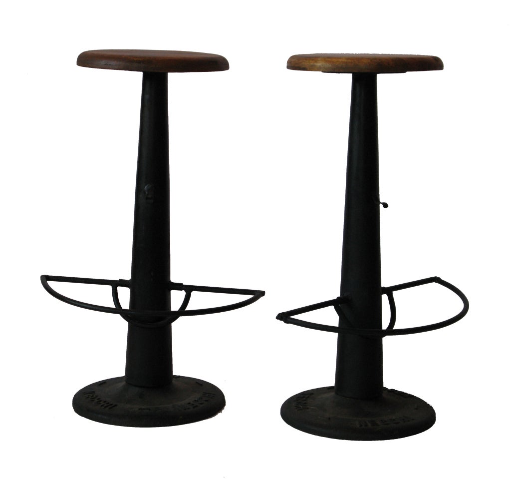 Beautifully executed pair of reproduction stools modeled after ones used in a Necchi sewing machine factory in Italy during the 1920's. Every attention to detail was taken in the reproduction of these pieces. The finishes, stamping, and weight of