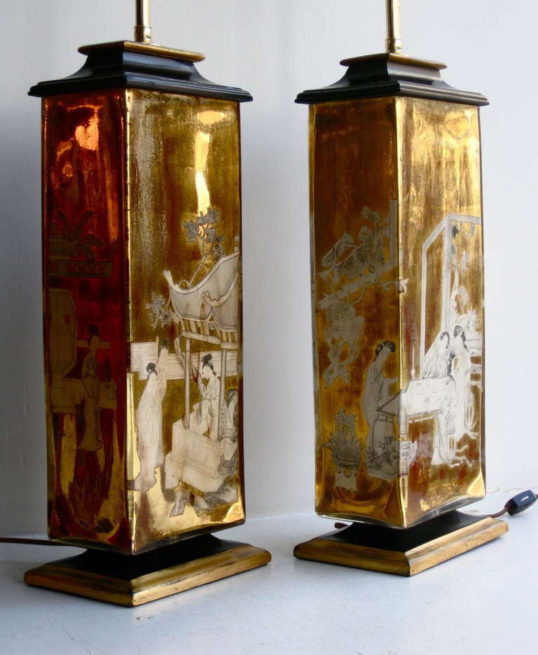 Pair of eglomise Chinoiserie glass table lamps with internally applied gold leaf and reverse painting of an Asian scene attributed to James Mont, circa 1940's. The pagoda style painted wood bases and caps have been restored.  Lamps are re-wired with