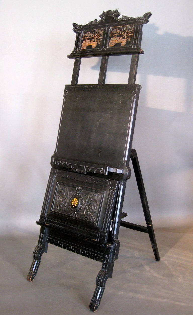 Ebonized wood Aesthetic Movement adjustable easel with carved wood portfolio panel and incised decoration in the Japonaise style made in America c.1890s.

WEEKLY DELIVERIES TO MANHATTAN FOR APPROVAL OR SALES. STANDARD DELIVERY FEE IS $150.