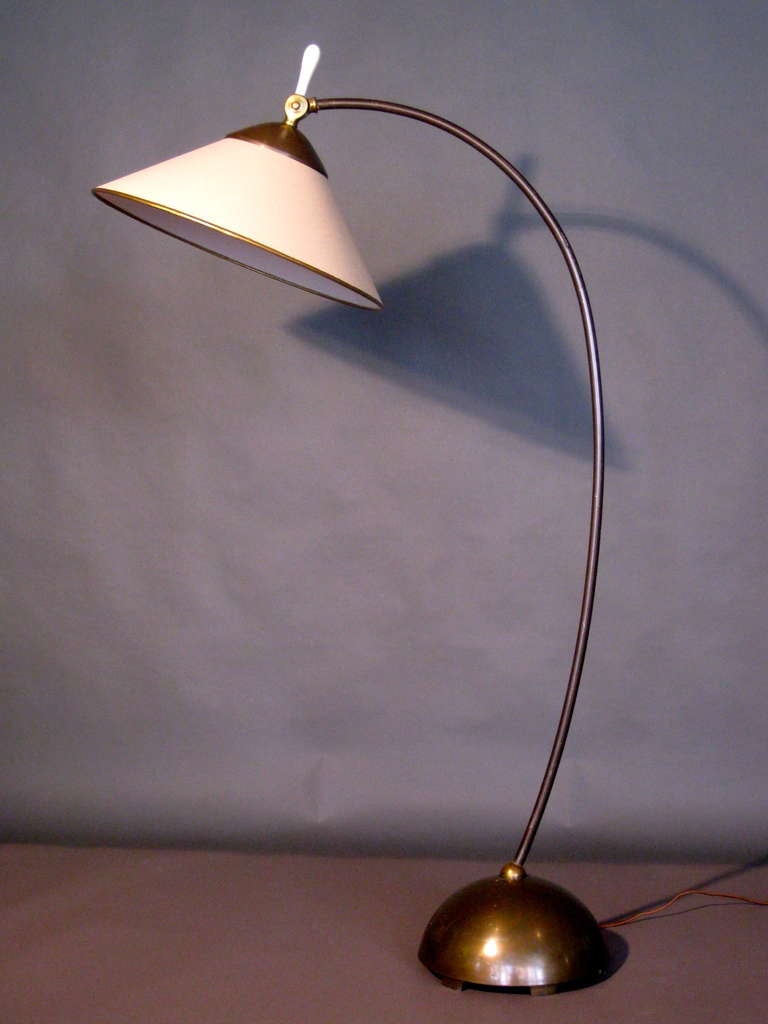 Early Russel Wright adjustable floor lamp of brass and brass plated steel circa 1935. Original shade has been recovered. Original milk glass finial has been replaced. Re-wired with brown silk cord.

Weekly deliveries to Manhattan for approval or