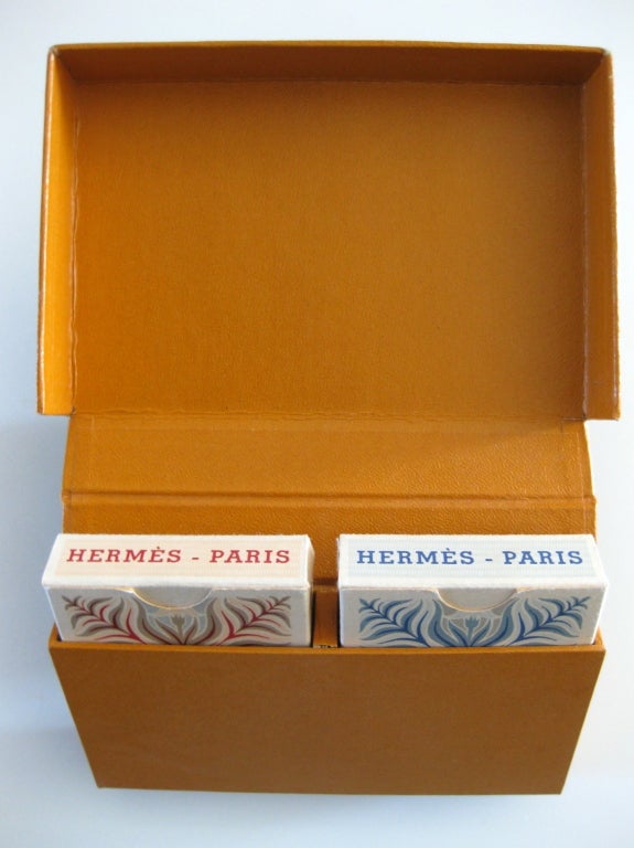 First edition set of two decks of poker playing cards designed by A.M. Cassandre in 1947 for the French firm Hermes. Still in their original individual boxes inside the original Hermes outer box. The blue deck has 52 playing cards, 1 joker, and the