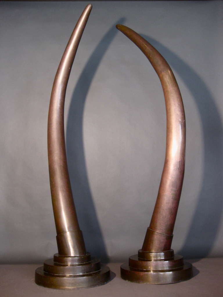 Pair of bronze elephant tusks on brass stepped bases c.1970s. Wonderful patina.

WEEKLY DELIVERIES TO MANHATTAN FOR APPROVAL OR SALES. DELIVERY FEE IS $150.