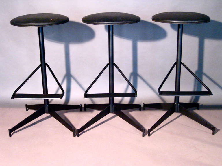Set of three steel & wrought iron bar stools with foot rests and swiveling seats.

Weekly deliveries to Manhattan for approval or sales. Standard delivery fee is $150.