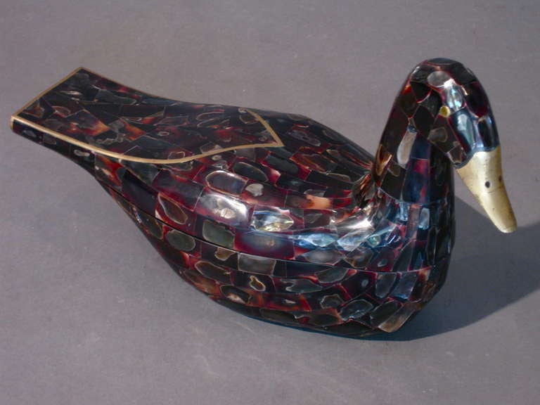 Pair of jewel like duck shaped wooden boxes/jewelry boxes covered in abalone shell and horn with inlaid brass and brass beaks made by Maitland-Smith in the Phillipines c.1970s. The ducks are not identical and one is .75