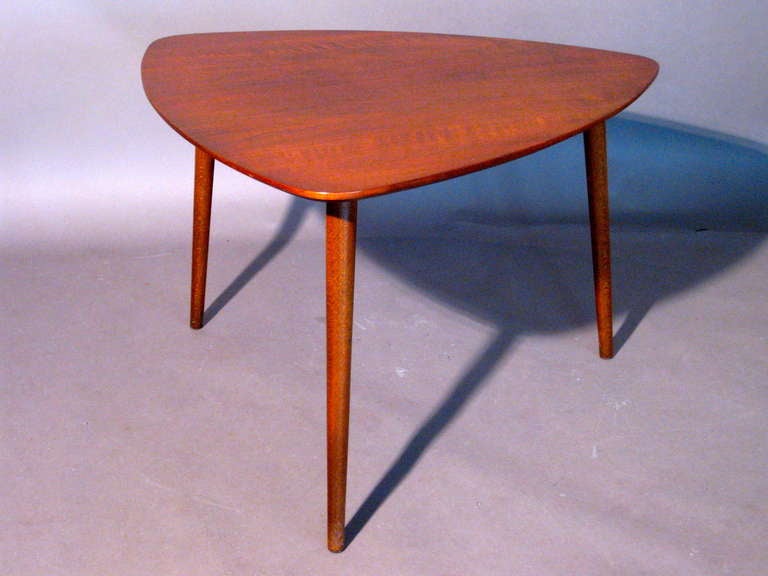 Triangular shaped walnut tripod side table made in Denmark for Raymor c.1950s. Still retains metal label underneath 