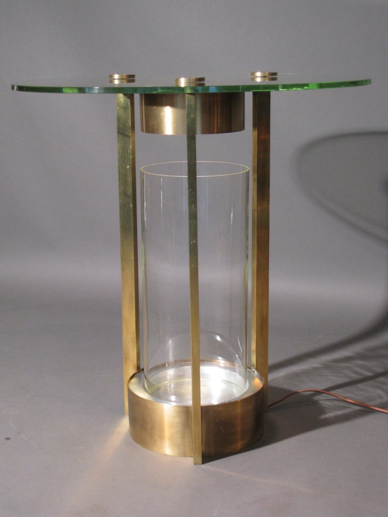 Illuminated brass side table with removable glass terrarium designed by Dorothy Thorpe c.1950s. Original glass & glass terrarium. Re-wired with brown silk cord.

WEEKLY DELIVERIES TO MANHATTAN FOR APPROVAL OR SALES. STANDARD DELIVERY FEE IS $150.