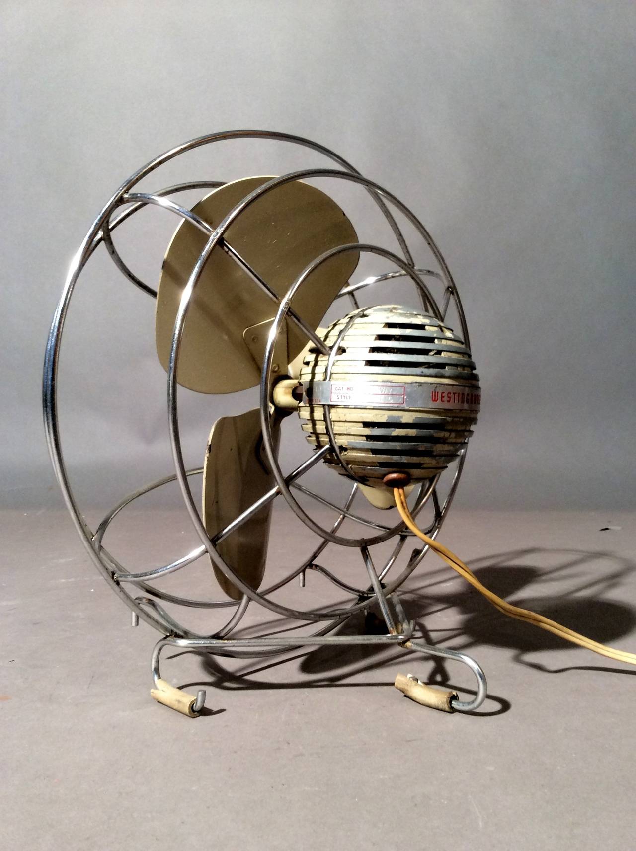 Modernist or Art Deco table fan by Westinghouse, circa 1940s. Great example of American Industrial Design with inventive placement of the motor encased in a metal ball in the rear of the fan. Good original working condition.

Weekly deliveries to