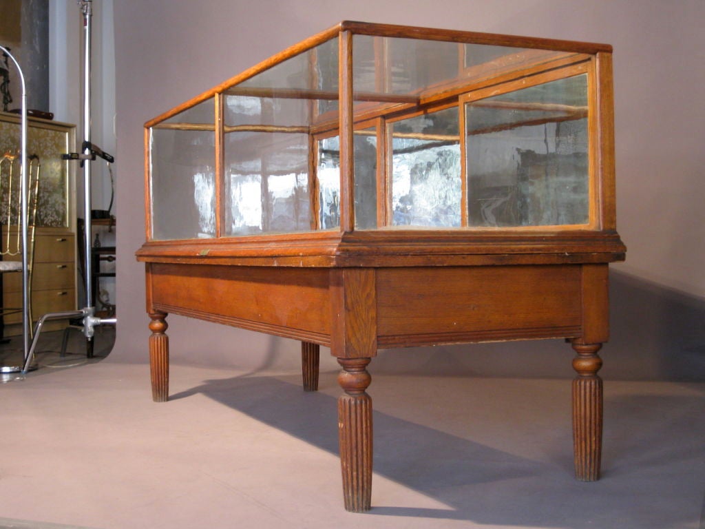 Oak, glass, and mirrored glass show case / vitrine mfg. by James Irons of Philadelphia in the early 20th Century. All original glass, including mirrored rear sliding doors and original finish on wood frame and base. Glass and wood display element