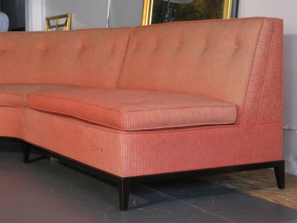 Three piece sectional sofa with wood trim base and legs designed by T.H. Robsjohn-Gibbings for Widdicomb c.1950's. Retains original Widdicomb label on upholstery decking. Wooden base has new dark mahogany hand rubbed finish. Original upholstery