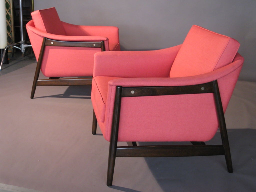 Pair of upholstered lounge chairs designed by Folke Ohlsson in Sweden for DUX c.1950's. New hand rubbed dark brown finish on wood frame and new coral colored linen upholstery.

WEEKLY DELIVERIES TO MANHATTAN FOR APPROVAL OR SALES. DELIVERY FEE IS