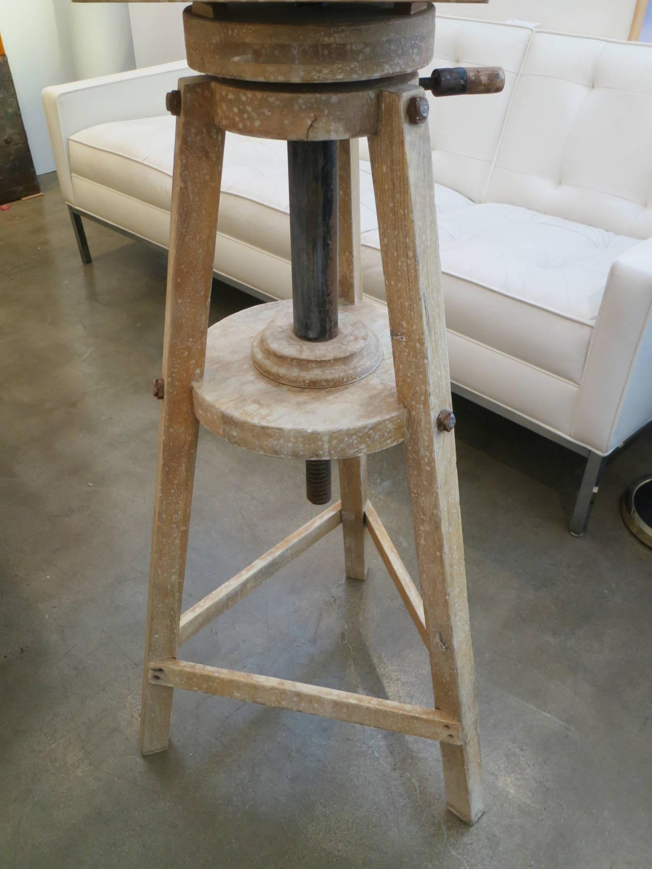 This is a great vintage piece. The color and patina is so soft. The top is a steel plate. It is fully adjustable to display your favorite item! The height listed is for the platform at its lowest. The larger dimension is the distance from leg to leg