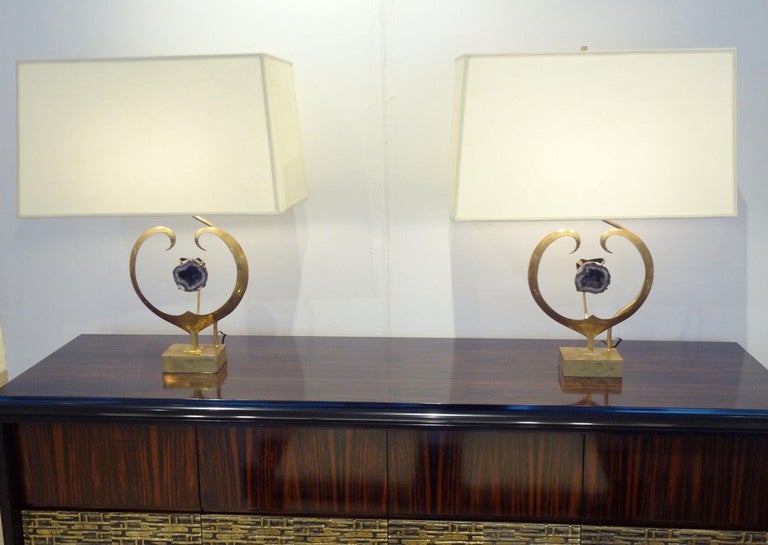 An exceptional pair of table lamps each featuring bodies in brass with curving side panels which surround a central mounted piece of Amethyst Quartz. The lamps also feature large rectangular shades and on / off cord switches. Willy Daro, Belgium