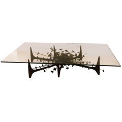 A Mid Century Modernist Cocktail Table in Wrought Iron and Glass