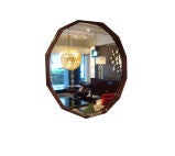 A Round Mid Century Wall Mirror in a Faceted Rosewood Frame