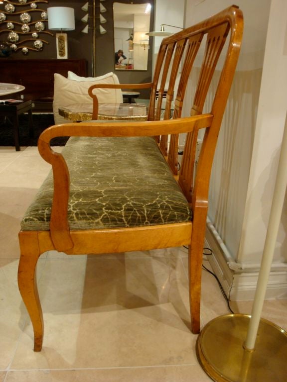An Antique Armed Bench in Flamed Birch