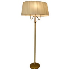 A Brass and Lacquer Floor Lamp in the style of Fontana Arte