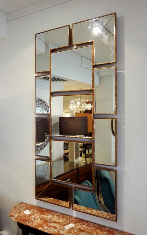 A large scaled rectangular shaped wall mirror featuring a multi paned body, each framed in gold leaf. Unknown, France circa 1975.<br />
<br />
PLEASE NOTE, ONLY A SMALL SAMPLE OF OUR COLLECTION APPEARS ON 1STDIBS. VISIT OUR WEBSITE