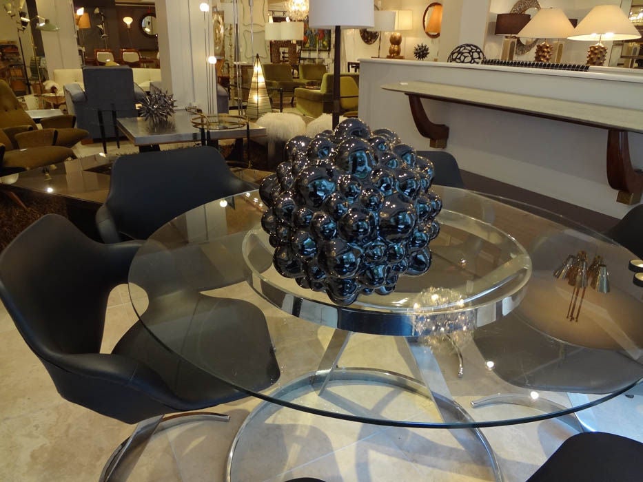 Pamela Sunday creates hand built ceramic sculptures that are inspired by nature and science. This example, titled Atom, is realized in stoneware with a high-luster black glaze. Each of Pamela's sculptures are unique, as they are hand crafted. Pamela