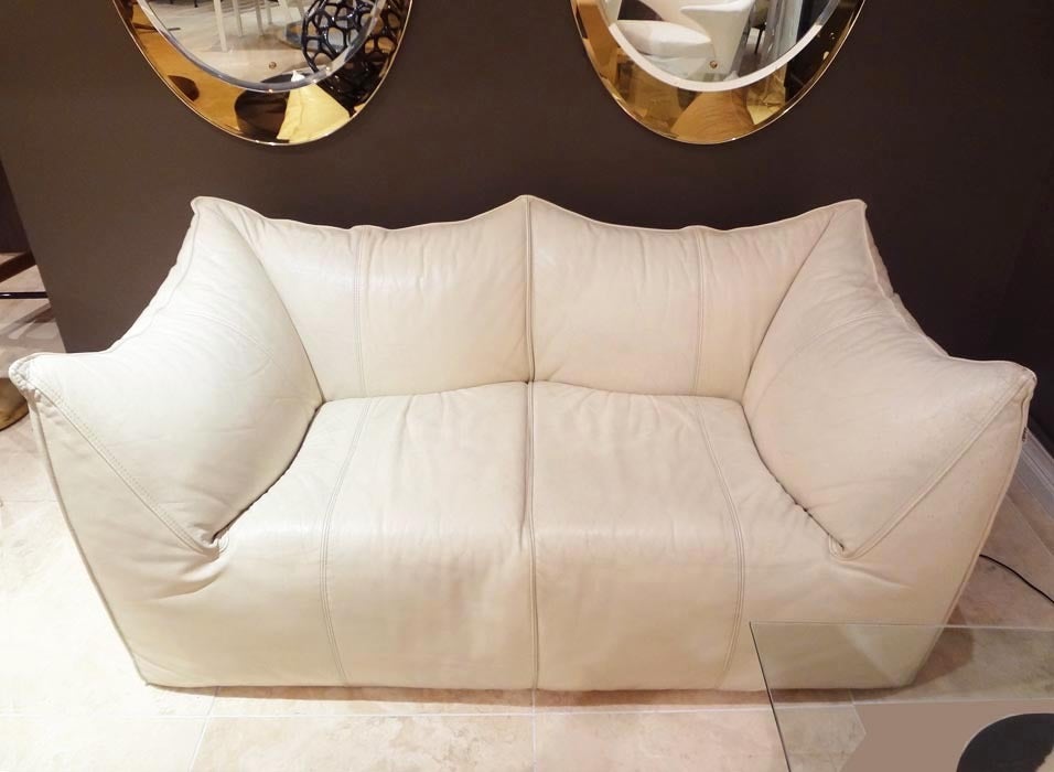 A vintage sofa, model Bambole, featuring a pillow formed back, arm rests and seats in original creamy white leather. By Mario Bellini for B&B Italia, Italy circa 1975.