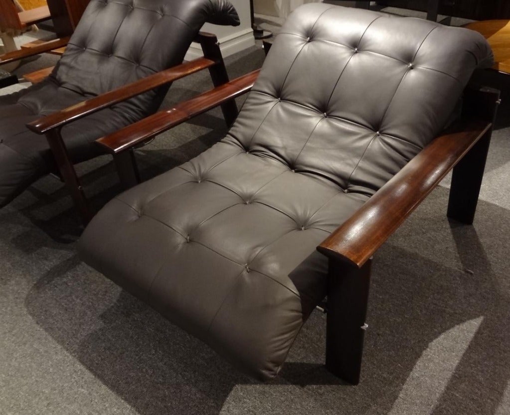 A pair of modernist club chairs each featuring open frames of Mahogany with nickle detailing and all new tufted deep brown leather upholstery. By Percival Lafer, Brazil, circa 1965.