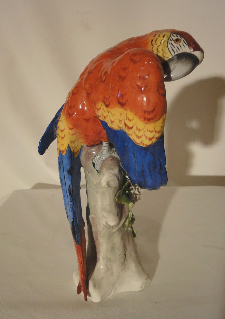 Pair of Modern German Porcelain Parrots perched on floral encrusted tree stumps. Each Parrot bears a mark on the underside which appears to belong to the German porcelain maker Voigt/Sitzendorf, & in addition to the maker's mark, also found on the