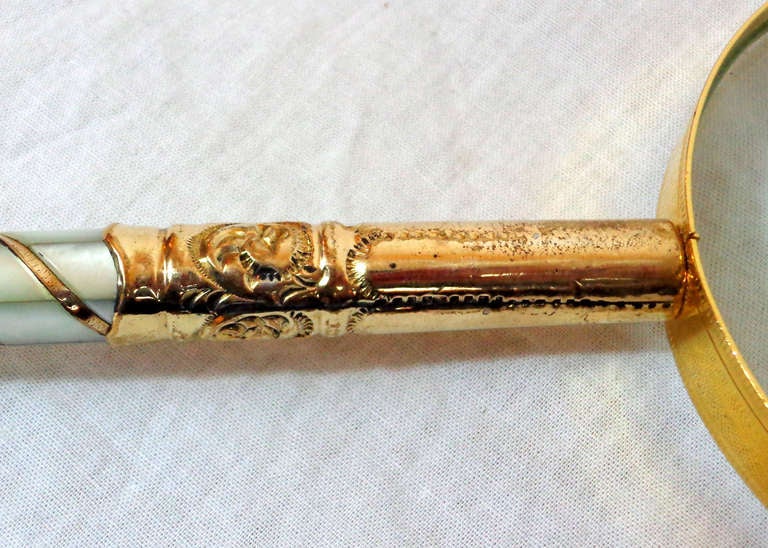 Parasol handle of vermeil and mother-of-pearl, now affixed to a magnifying glass.

The bottom is inscribed 