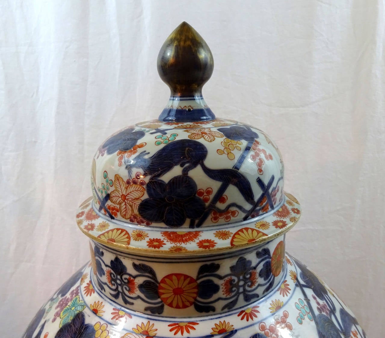 Early 19th century Chinese porcelain vase of a large size with cover in the Imari taste with later bronze base.