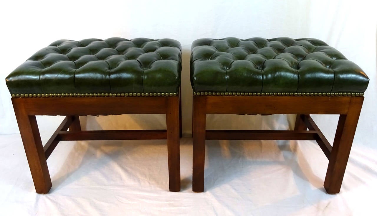 Pair of 20th century stools with green leather tufted upholstery and nailhead trim.