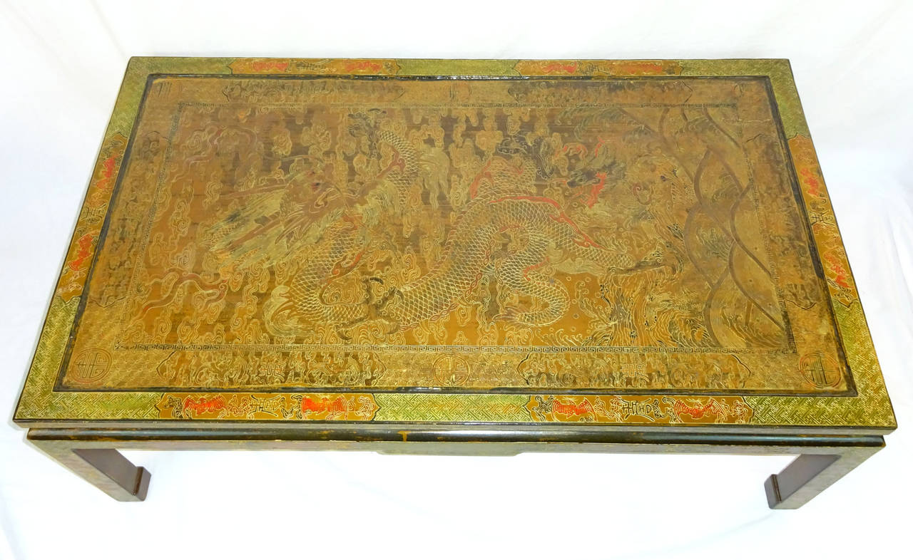 19th century Chinese panel with red, green, and gold detail featuring a Chinese Dragon, now as a cocktail table with later base and legs created in France.