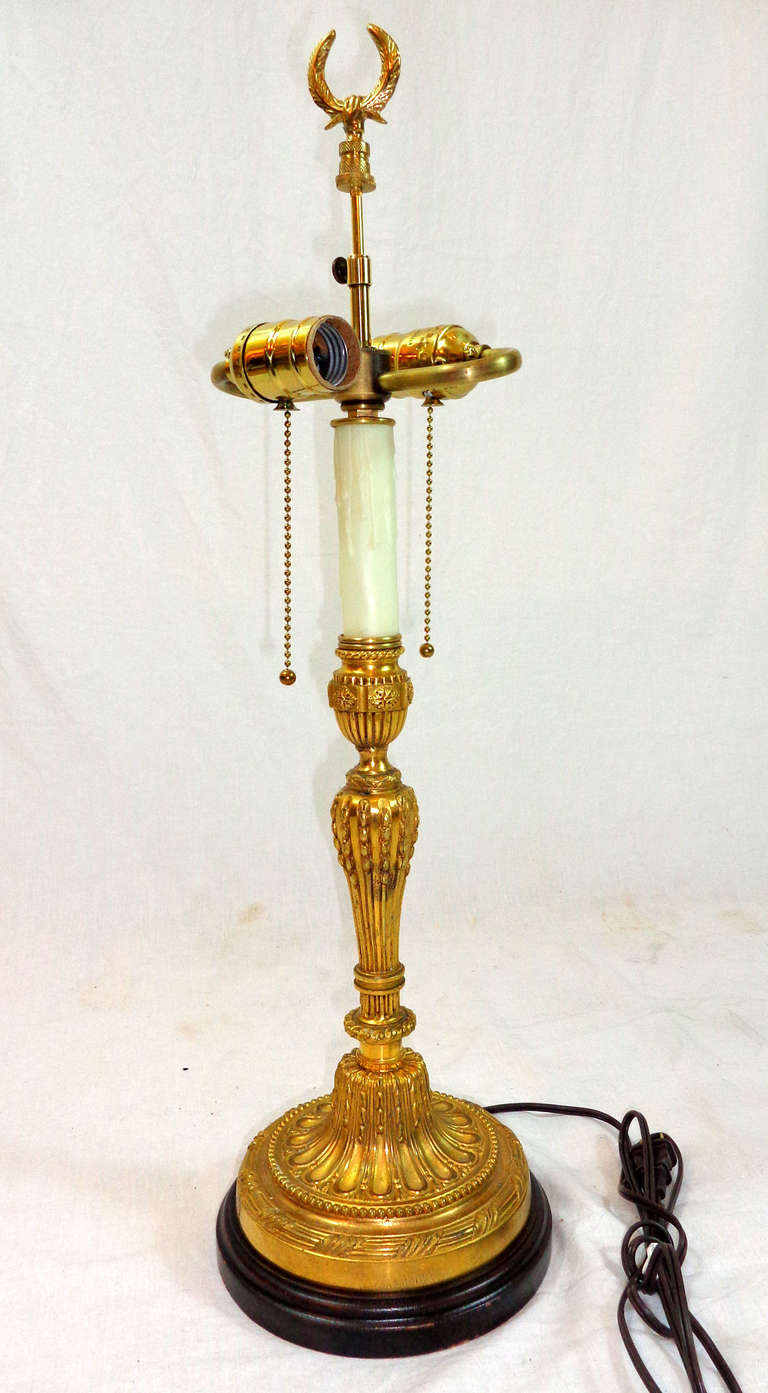 Louis XVI Style Bronze Doré Candlestick now as a lamp fitted for electricity and a wooden base.