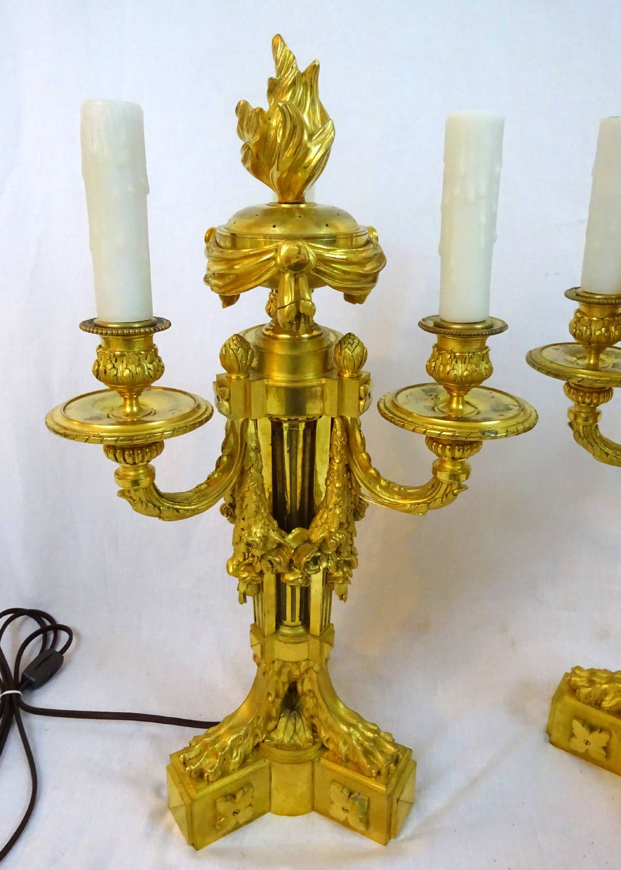 Pair of very fine Louis XVI style gilt bronze Ormolu three-light candelabra now as lamps with central perfumier topped by a flame shaped lid.