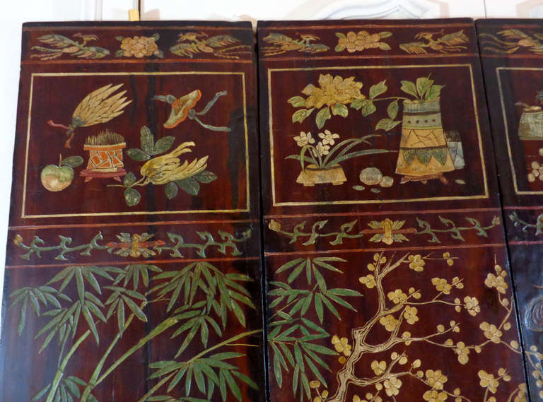 19th century Chinese screen consisting of four panels depicting a nature scene of birds and animals amidst plants and flowers. These are likely the four central panels from what was once a six-panel screen. The reverse sides depict a mountain scene